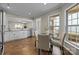 Bright open kitchen with white cabinetry, stainless steel appliances, hardwood floors, and a dining area at 250 Cherry Tree Dr, Fort Mill, SC 29715