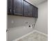 Laundry room features ceramic tile floors and dark cabinets at 250 Cherry Tree Dr, Fort Mill, SC 29715