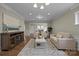 Well-lit living room featuring neutral paint, hardwood floors, modern furniture, and an open layout at 250 Cherry Tree Dr, Fort Mill, SC 29715