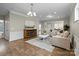 Spacious living room with hardwood flooring, fireplace, modern lighting, and neutral colors at 250 Cherry Tree Dr, Fort Mill, SC 29715