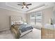 Carpeted main bedroom with tray ceiling, ceiling fan, neutral paint, and large window at 250 Cherry Tree Dr, Fort Mill, SC 29715