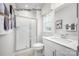 Bright bathroom featuring a shower, white vanity with modern fixtures, and neutral wall paint at 2533 Ellen Ave # 1016B, Charlotte, NC 28208