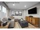 Stylish living room featuring a gray sofa, ottoman, entertainment center, and modern decor at 2533 Ellen Ave # 1016B, Charlotte, NC 28208