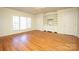 Spacious bedroom with hardwood floors, built-in shelving, and large window at 258 Fenton Pl, Charlotte, NC 28207