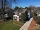 Brick house with a classic design, a columned porch, and manicured lawn at 258 Fenton Pl, Charlotte, NC 28207