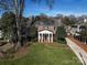 Brick house with a classic design, a columned porch, and manicured lawn at 258 Fenton Pl, Charlotte, NC 28207