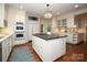 Modern kitchen with double ovens, large island, and upgraded cabinetry at 258 Fenton Pl, Charlotte, NC 28207