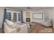 Open-concept living room featuring hardwood floors, fireplace, and French doors at 2604 Cochrane Dr, Charlotte, NC 28269