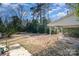 Large, empty, tree filled backyard with a covered structure at 2624 Ashley Rd, Charlotte, NC 28208