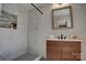 Modern bathroom with decorative tile shower, sleek vanity with wood accents, and a contemporary mirror at 2624 Ashley Rd, Charlotte, NC 28208