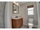 Well-lit bathroom with a modern vanity, stylish fixtures, and window with a wooden blind at 2624 Ashley Rd, Charlotte, NC 28208