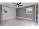 Bright bedroom with a modern ceiling fan, neutral walls, and beautiful laminate flooring at 2624 Ashley Rd, Charlotte, NC 28208