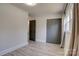 Bright bedroom features a gray accent wall, closet with folding doors, and a window with neutral curtains at 2624 Ashley Rd, Charlotte, NC 28208