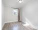 Neutral bedroom with lots of natural light and wood-look flooring at 2624 Ashley Rd, Charlotte, NC 28208