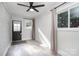 Sunroom featuring a modern ceiling fan, neutral walls, and beautiful laminate flooring at 2624 Ashley Rd, Charlotte, NC 28208