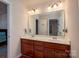 Bathroom with double vanity, mirror, and shower at 2748 Smethwick Ln, Gastonia, NC 28056