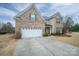 Two-story brick home with a white garage door and driveway at 2748 Smethwick Ln, Gastonia, NC 28056