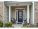 Front entrance with black door and wicker chairs at 2748 Smethwick Ln, Gastonia, NC 28056