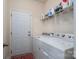 Laundry room with washer, dryer, and shelving at 2748 Smethwick Ln, Gastonia, NC 28056