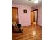 Bedroom with hardwood floors and access to hallway at 29086 Sweet Home Church Rd, Albemarle, NC 28001