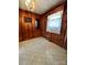 Wood paneled dining area with wood floors and built-in shelving at 29086 Sweet Home Church Rd, Albemarle, NC 28001