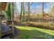 Landscaped backyard with lush greenery and wooded backdrop at 303 Edgewood Rd, Shelby, NC 28150