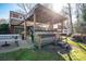 Lighted backyard patio with pergola, seating, and picnic table at 303 Edgewood Rd, Shelby, NC 28150