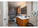 Clean basement bathroom with wood vanity and striped shower curtain at 303 Edgewood Rd, Shelby, NC 28150