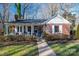 Brick ranch house with covered porch and landscaped yard at 303 Edgewood Rd, Shelby, NC 28150