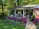 Charming brick house with a porch adorned with blooming azaleas at 303 Edgewood Rd, Shelby, NC 28150