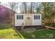 White storage shed with two windows and a snowman decoration at 303 Edgewood Rd, Shelby, NC 28150