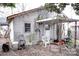 Exterior of the home displays a covered porch, overgrown greenery, and yard in need of maintenance at 316 E 4Th Ave, Gastonia, NC 28054