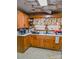 Traditional kitchen with wooden cabinets, white countertops, and a window above the sink at 316 E 4Th Ave, Gastonia, NC 28054