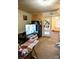 Cozy living room area with a refrigerator, television, and doorway leading to the dining area at 316 E 4Th Ave, Gastonia, NC 28054