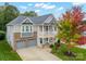 Two-story house with gray siding, stone accents, and a two-car garage at 3205 Helmsley Ct, Concord, NC 28027