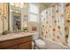 Clean bathroom with granite countertop and sunflower shower curtain at 3205 Helmsley Ct, Concord, NC 28027