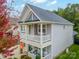 Two-story house with gray siding, stone accents, and a balcony at 3205 Helmsley Ct, Concord, NC 28027