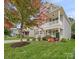 Two-story house with gray siding, stone accents, and fall foliage at 3205 Helmsley Ct, Concord, NC 28027