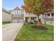 Two-story house with gray siding, stone accents, and a large tree in the front yard at 3205 Helmsley Ct, Concord, NC 28027