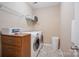 Laundry room with washer, dryer, and shelving at 3205 Helmsley Ct, Concord, NC 28027