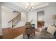 Living room with hardwood floors, neutral furniture, and a view of the staircase at 3205 Helmsley Ct, Concord, NC 28027