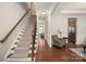 Elegant staircase with a wrought iron railing and neutral carpeting at 3205 Helmsley Ct, Concord, NC 28027