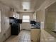 Kitchen with white cabinets, black appliances, and tile floor at 3219 Sutton Dr, Charlotte, NC 28216