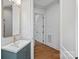 Stylish bathroom featuring a modern vanity with a gold faucet and mirror, and a doorway at 357 Magnolia St, Davidson, NC 28036