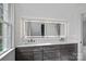 Bright bathroom featuring a double sink vanity and a backlit mirror at 357 Magnolia St, Davidson, NC 28036