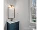 Stylish bathroom with a navy vanity, modern mirror, and natural lighting at 357 Magnolia St, Davidson, NC 28036