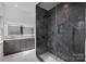 Modern bathroom featuring a large glass shower with dark marble and double sink vanity at 357 Magnolia St, Davidson, NC 28036