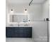 Elegant bathroom showcasing a double vanity, illuminated mirror, and frameless glass shower with marble tile at 357 Magnolia St, Davidson, NC 28036