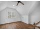 Bright bedroom with hardwood floors, a ceiling fan, and a window with a view at 357 Magnolia St, Davidson, NC 28036