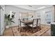 Elegant dining room with a modern chandelier, area rug, and a window, perfect for Gathering meals at 357 Magnolia St, Davidson, NC 28036